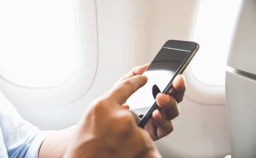 In-flight-connectivity-man-holding-mobile-phone